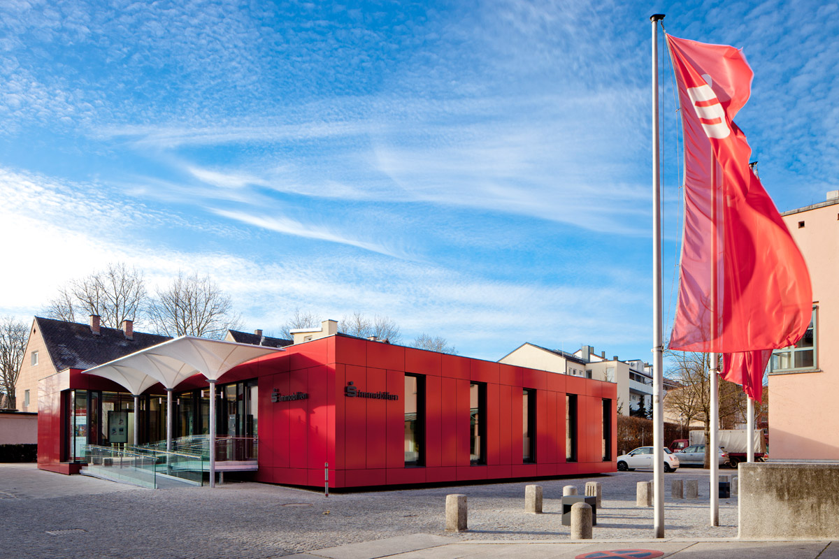 Holzbau Immobilien-Pavillon: Einstöckig fasst das Gebäude den Platz in Richtung Westen räumlich ein.